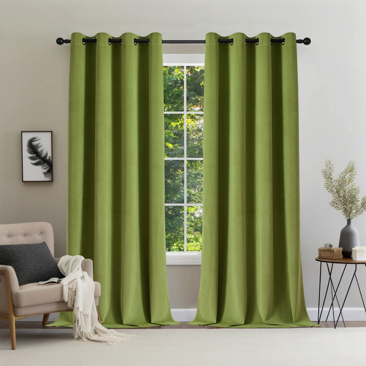 Moss green velvet blackout curtains with grommets, displayed in a room with a chair and side table.