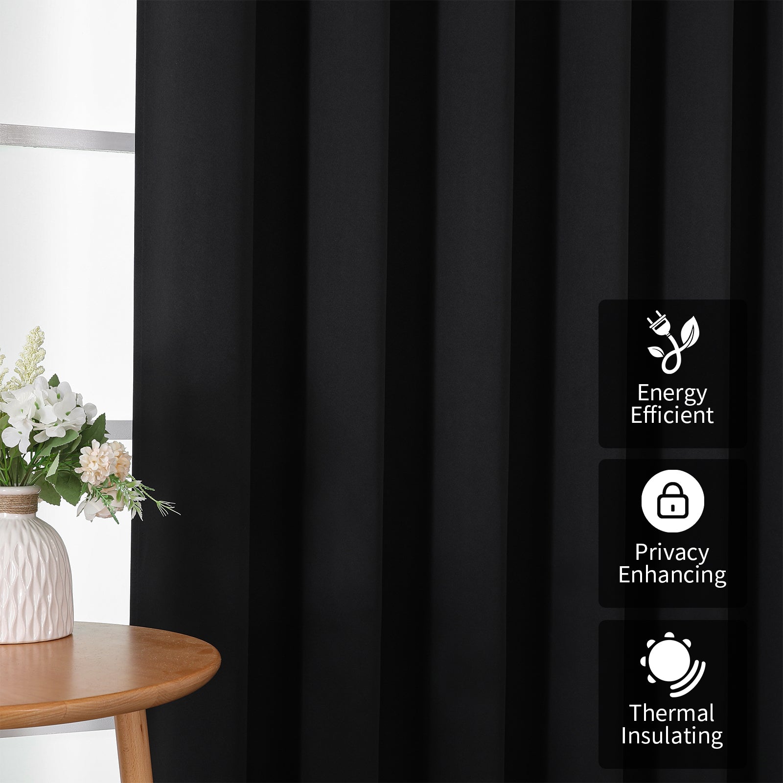 Close-up of black extra-wide blackout curtain with pleats, highlighting energy efficiency, privacy, and thermal insulation.