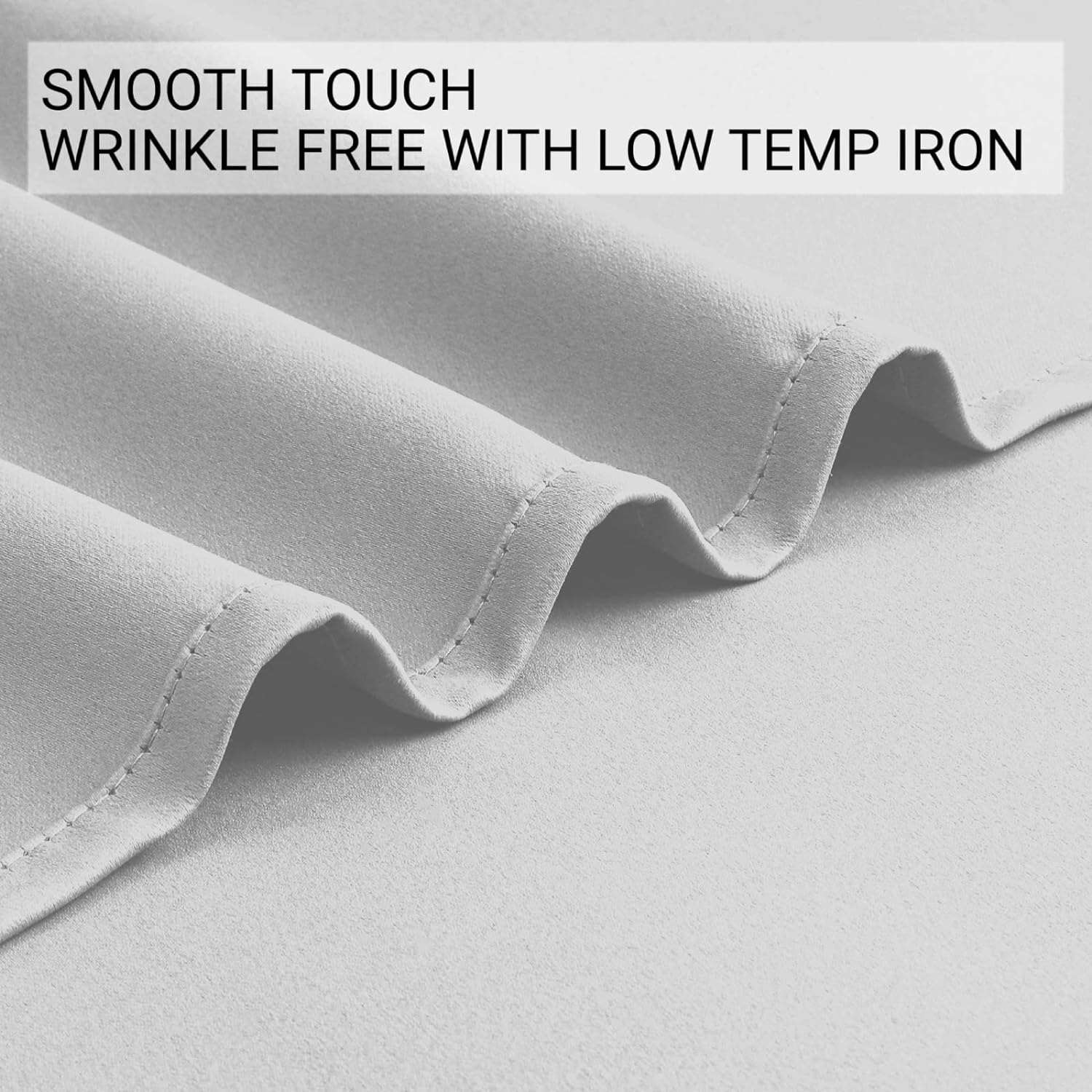 Close-up of light grey blackout curtain fabric showing smooth texture and wrinkle-free quality.