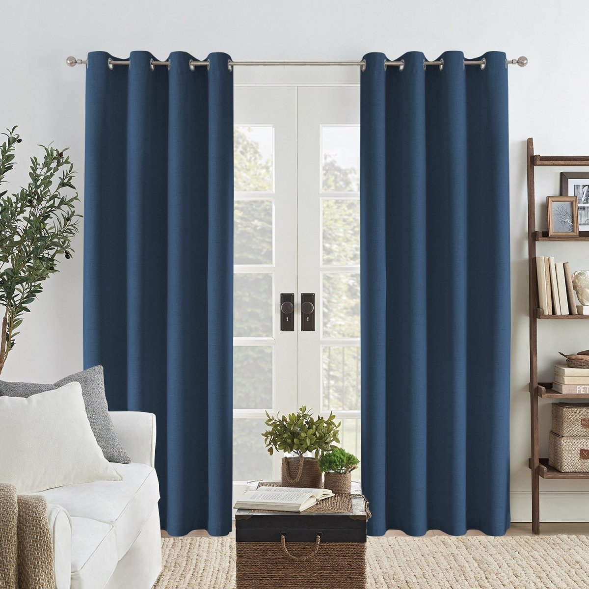 Navy blue linen blackout curtains with grommets framing French doors, enhancing living room decor with textured weave.