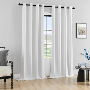 Two white Joydeco 100% blackout curtains with grommets, displayed in a modern room setting.