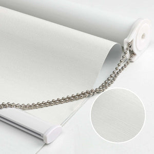 White 100% blackout roller shade with subtly textured fabric, metal pull chain, and close-up fabric detail inset.