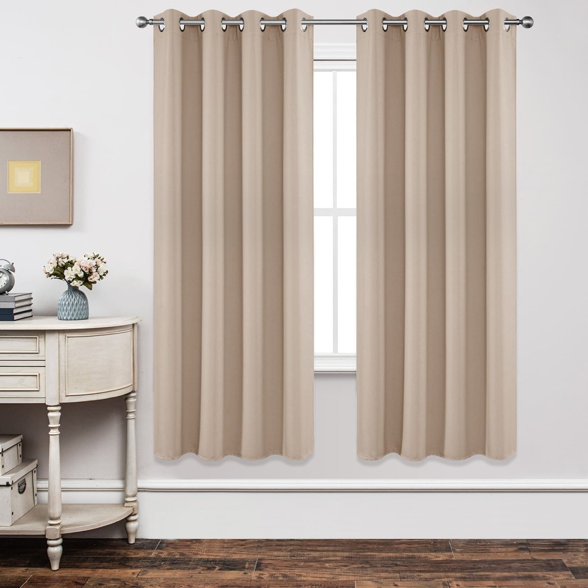 Joydeco beige grommet blackout curtains on silver rod, light-blocking, elegant decor.