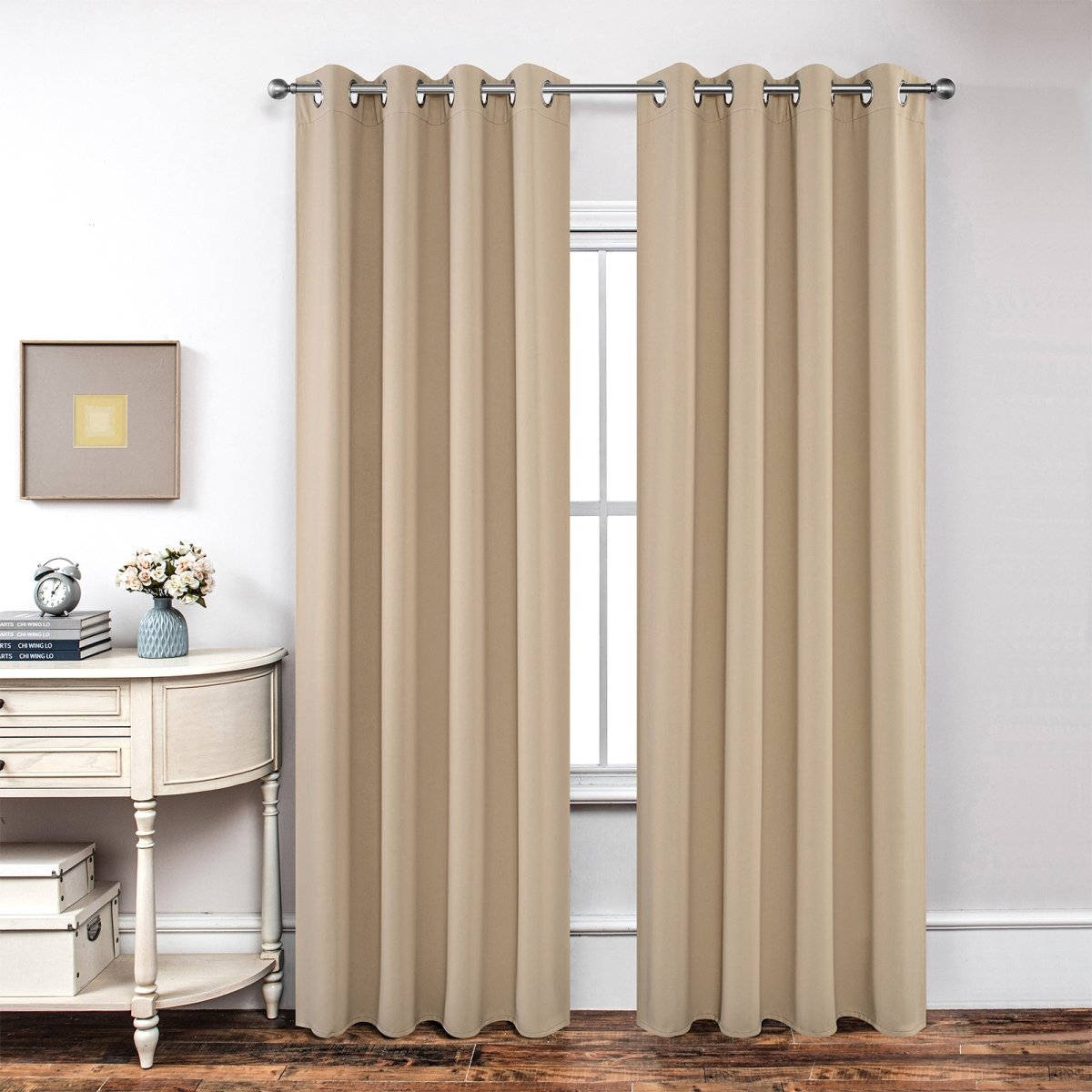 Joydeco classic beige blackout curtains with grommets covering a window, displayed with decor.