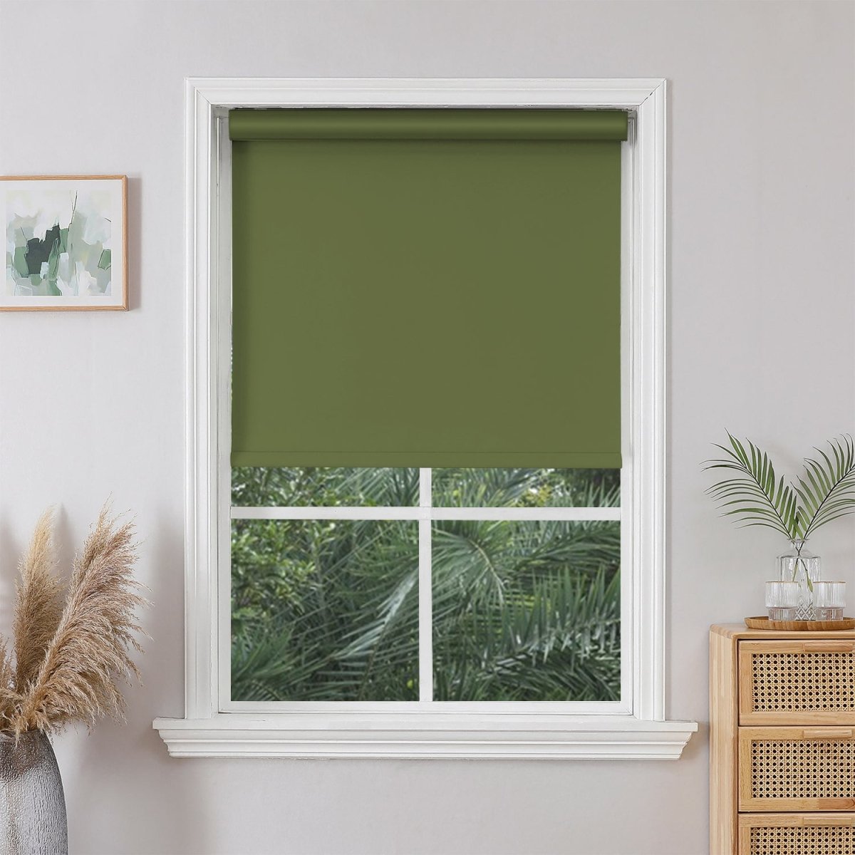 Hunter Green Joydeco cordless blackout roller shade installed in a white window, offering privacy and a modern look.