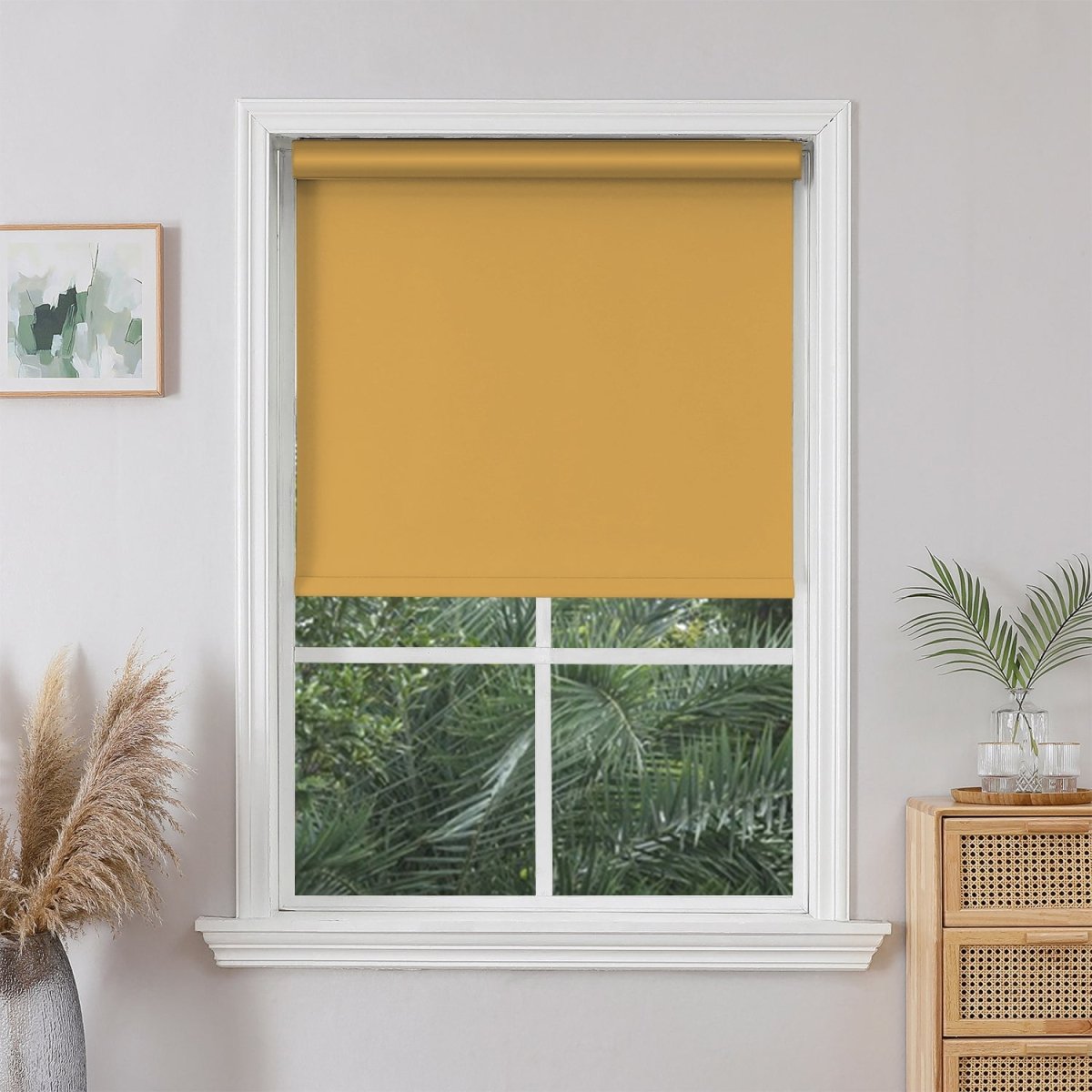Joydeco golden yellow cordless blackout roller shade on white window, modern blackout window treatment.