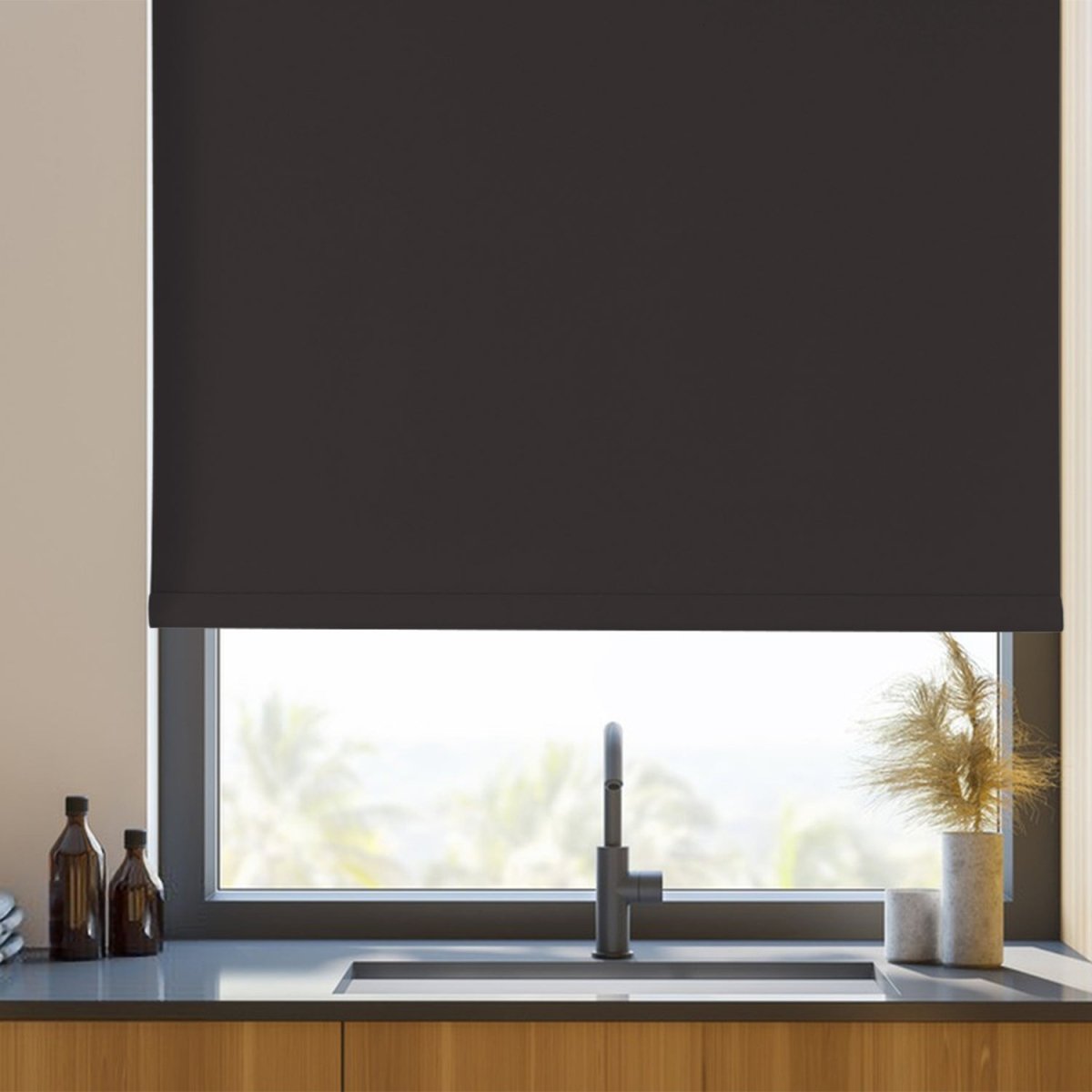 Joydeco dark gray cordless blackout roller shade in a kitchen window over sink. Blocks 100% light.