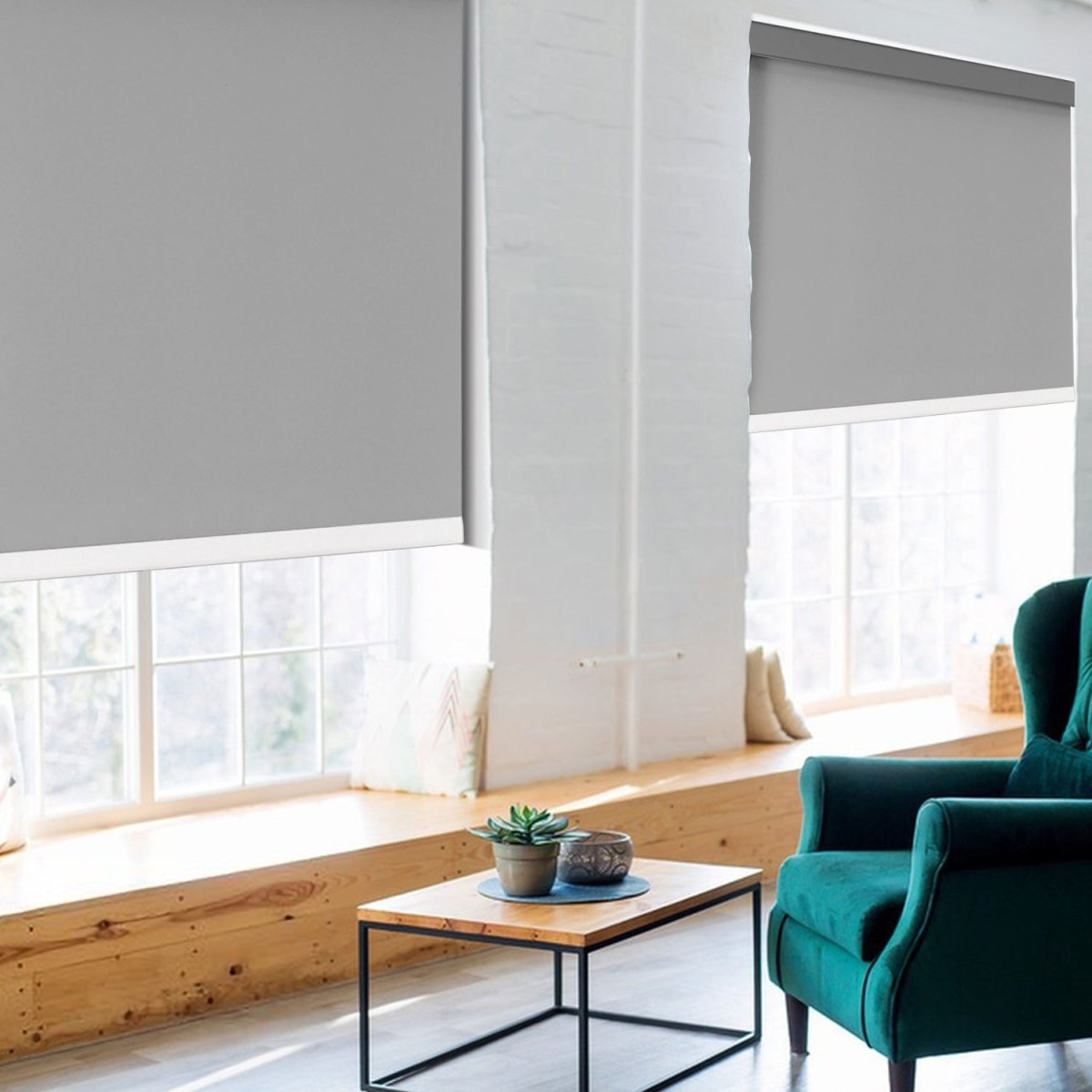 Joydeco grey cordless blackout roller shades installed on white windows in a living room with green armchair.