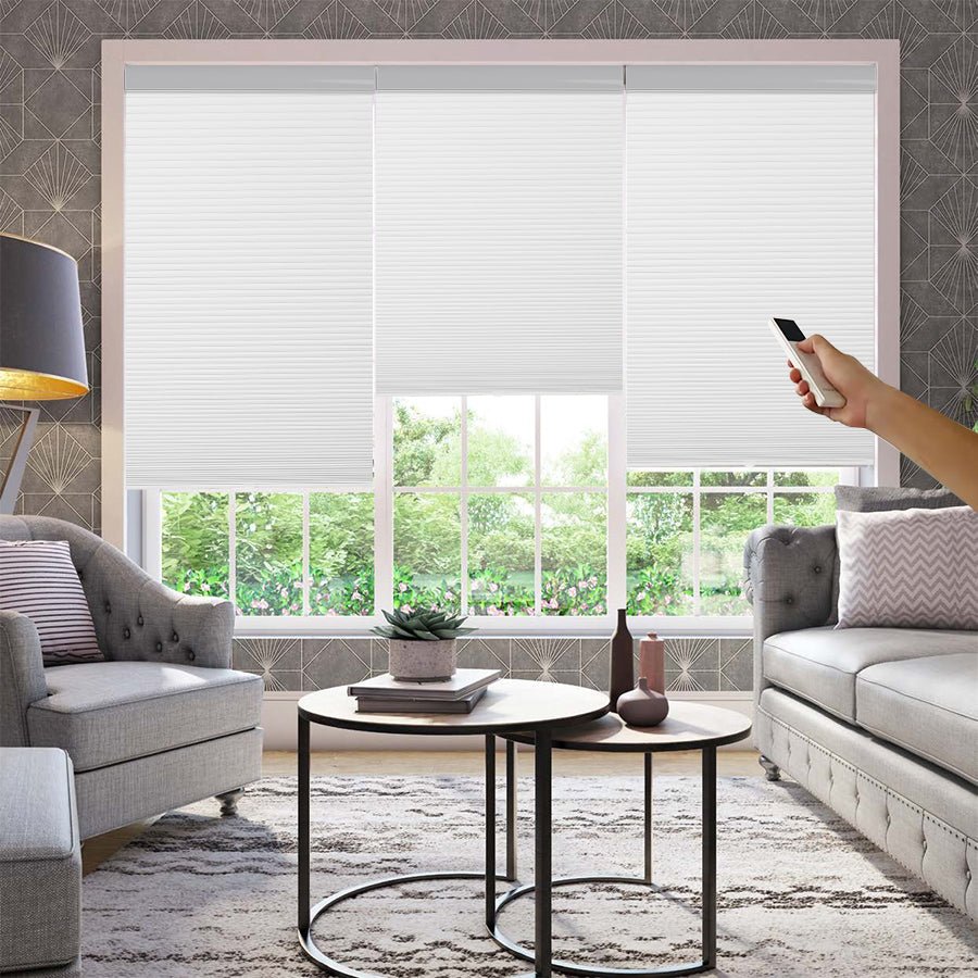 Joydeco white motorized blackout cellular shades operated by remote control in a modern living room.