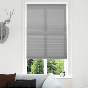 Joydeco custom light grey cordless motorized cellular shade, filtering light from outside trees.