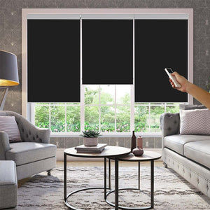 Black Joydeco motorized blackout roller shades controlled by remote in a modern living room.