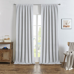Light grey custom linen blackout curtains with natural texture hung on a silver rod, enhancing room appearance and texture.