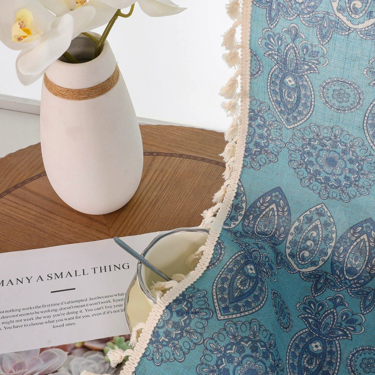 Joydeco blue bohemian curtains with intricate paisley design and cream tassel trim, close-up fabric detail.