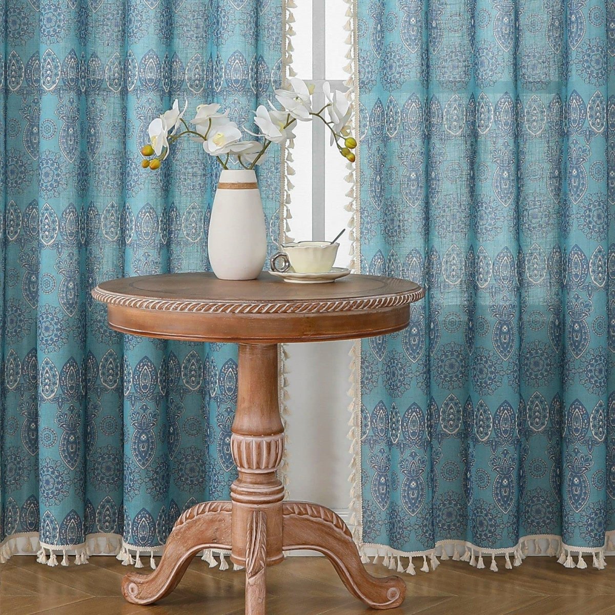 Joydeco blue bohemian curtains with medallion and paisley pattern, cream tassel trim, light filtering.