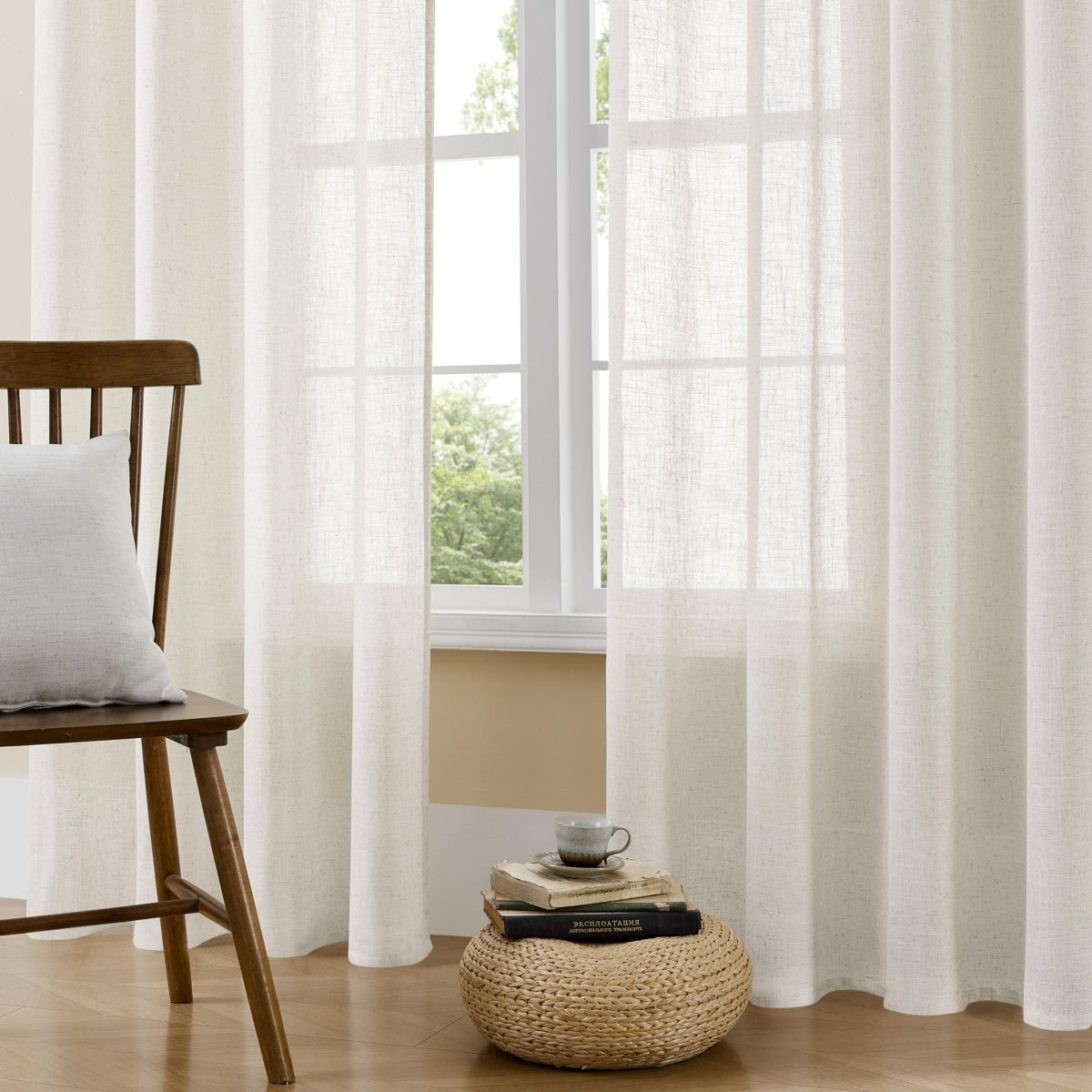 Off-white textured linen sheer curtains filtering light in a cozy living room.