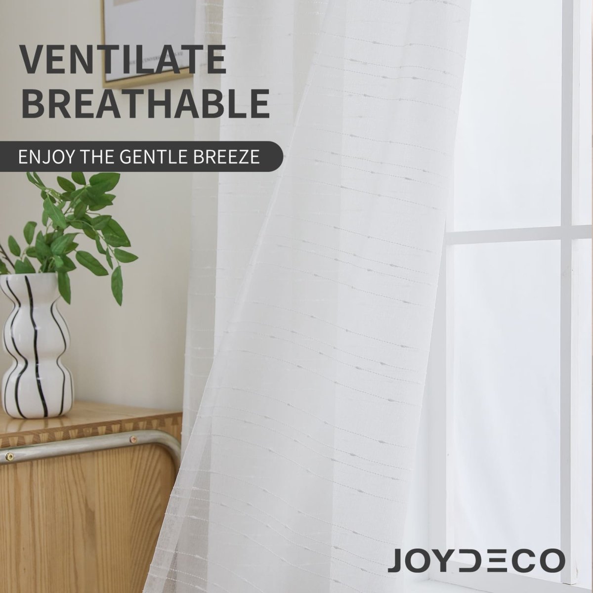 Joydeco white sheer curtains, lightweight with subtle texture, allowing natural light and airflow near a window.