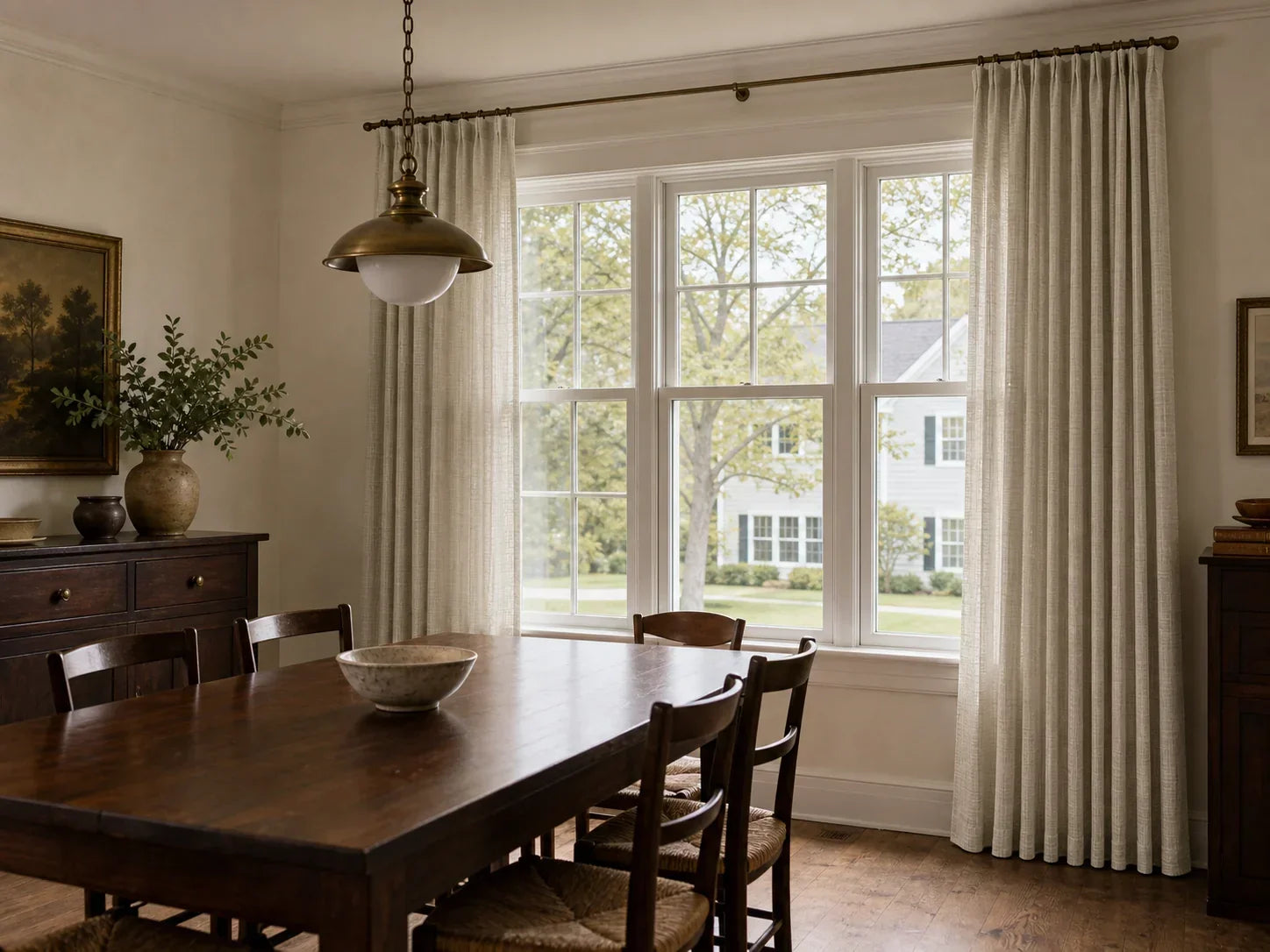 Joydeco light beige curtains brightening a dining room with dark wood furniture.