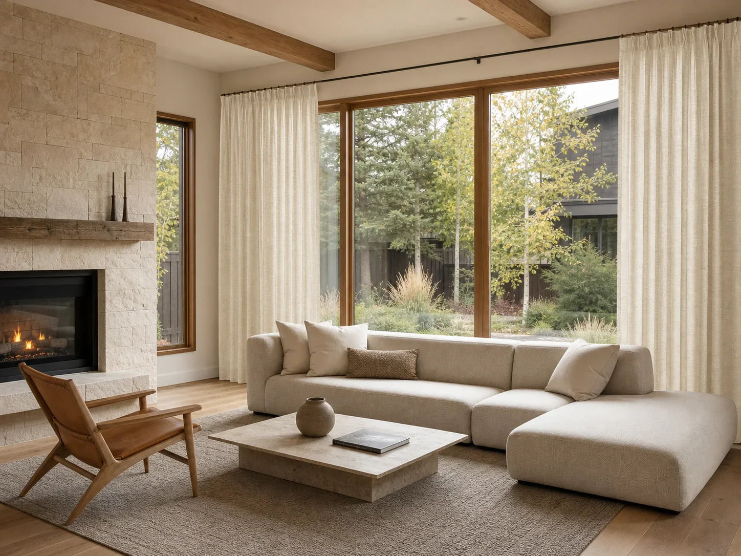 Joydeco neutral drapes styled with minimalist living room furniture and low sectional sofa.