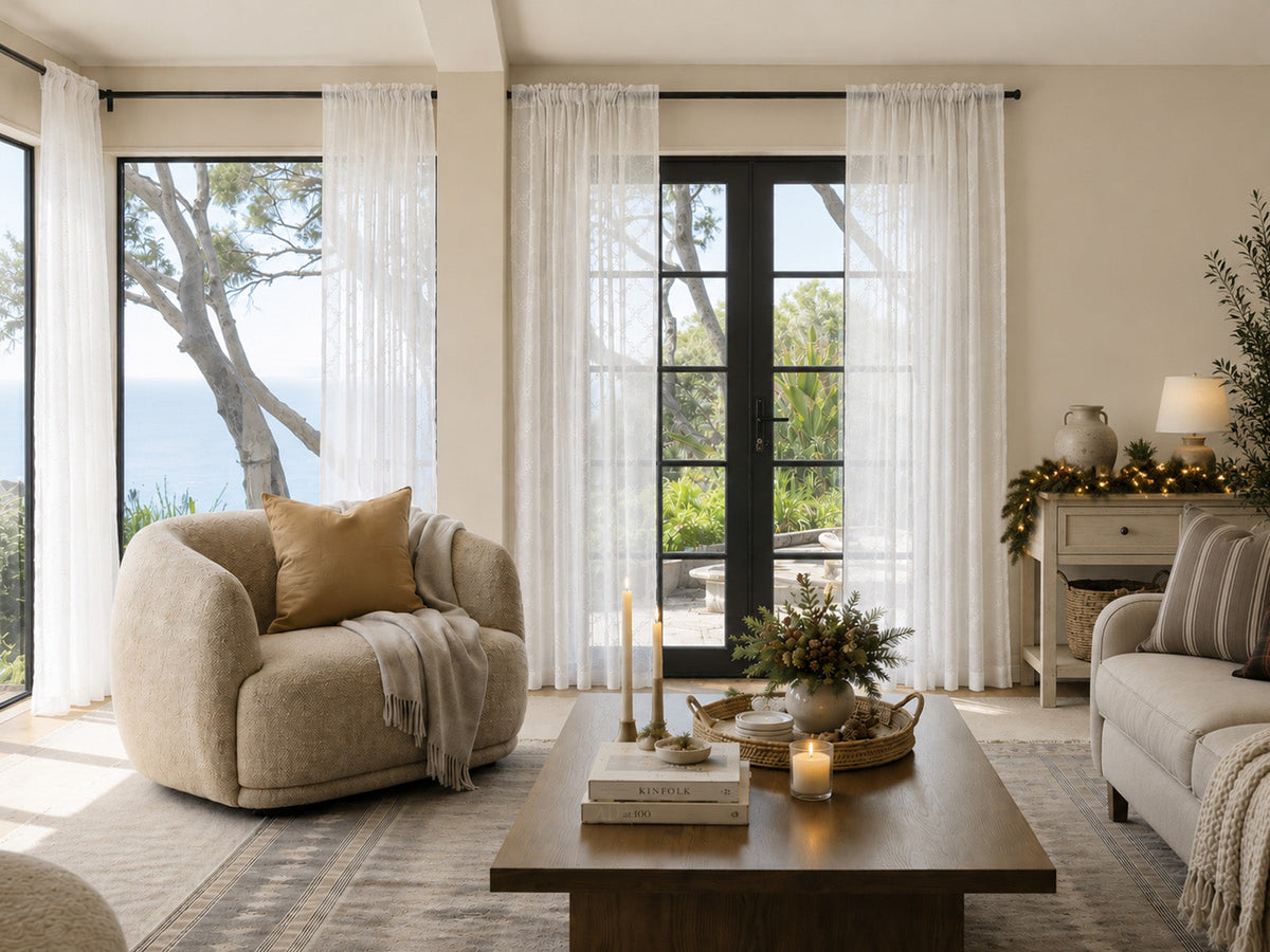 Bright living room with sheer white curtains on French doors, filtering natural daylight and adding soft texture to a modern space.