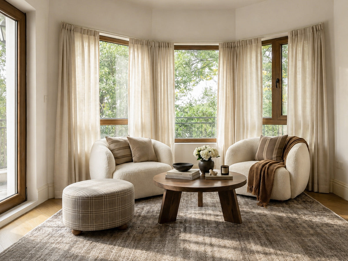 Joydeco cream sheer curtains on a bay window in a warm living room.