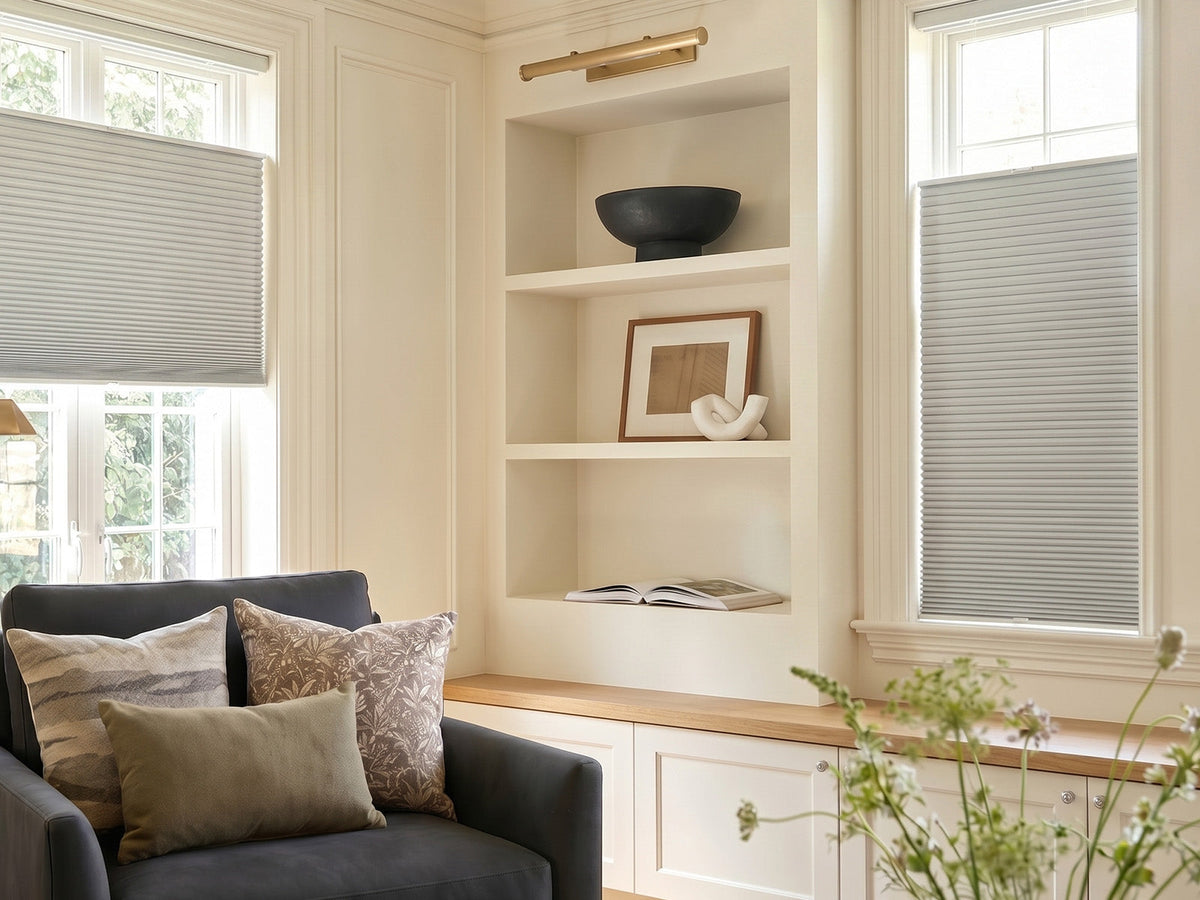 Joydeco light gray cordless cellular shades on windows in a cozy living room reading nook.