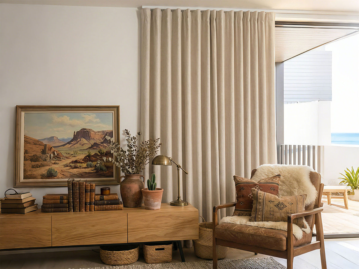 Joydeco beige blackout curtains drawn over a sliding glass door leading to a balcony.