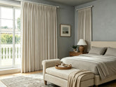 Joydeco pleated beige curtains paired with grey bedroom walls for a neutral look.