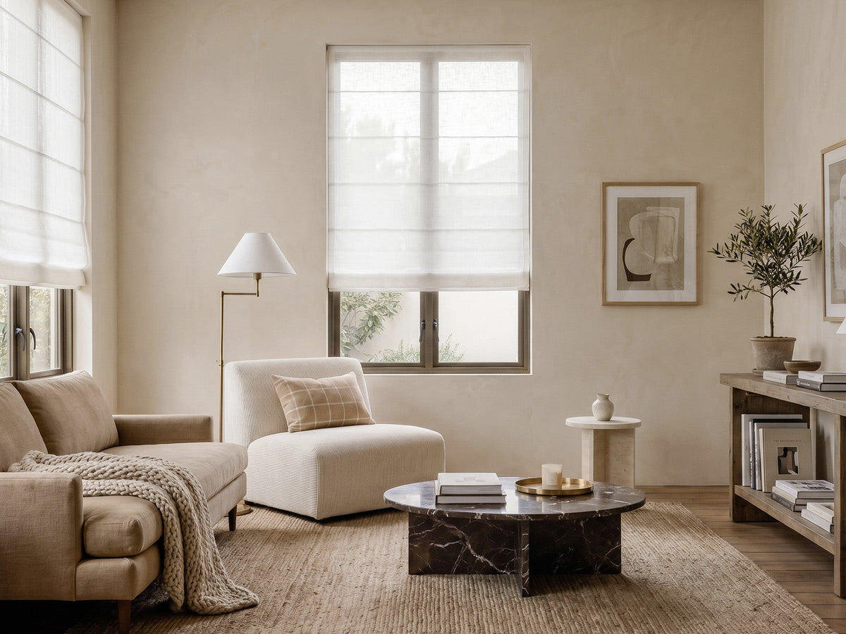 Joydeco white linen roman shades on large living room windows in a neutral beige lounge.