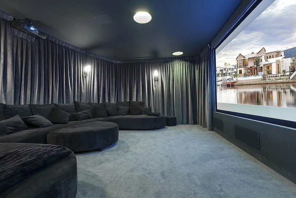 Joydeco silver velvet curtains in a luxury home theater with a large projection screen.