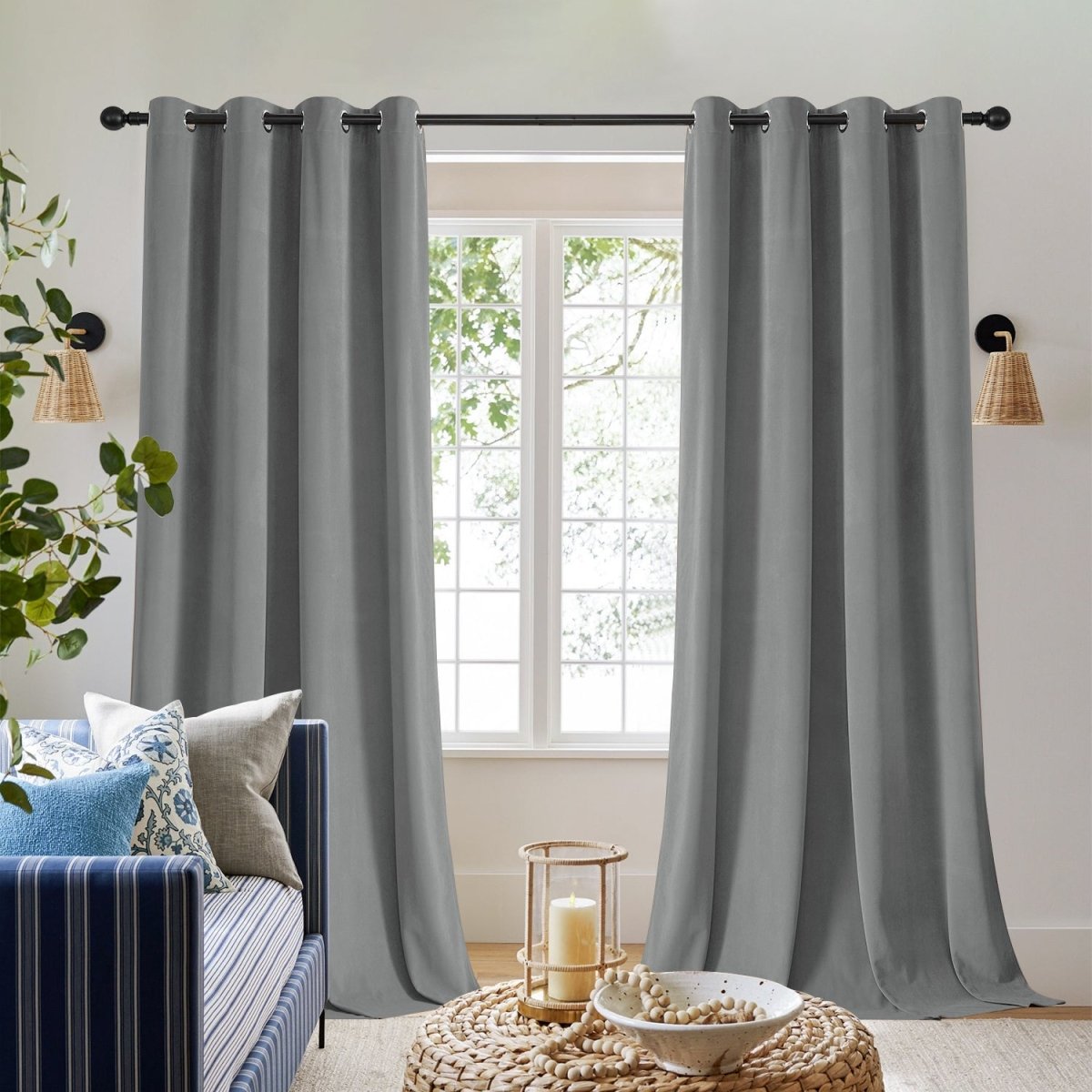 Two royal blue velvet blackout curtains with grommets, providing thermal insulation and privacy, on a window with a daybed.