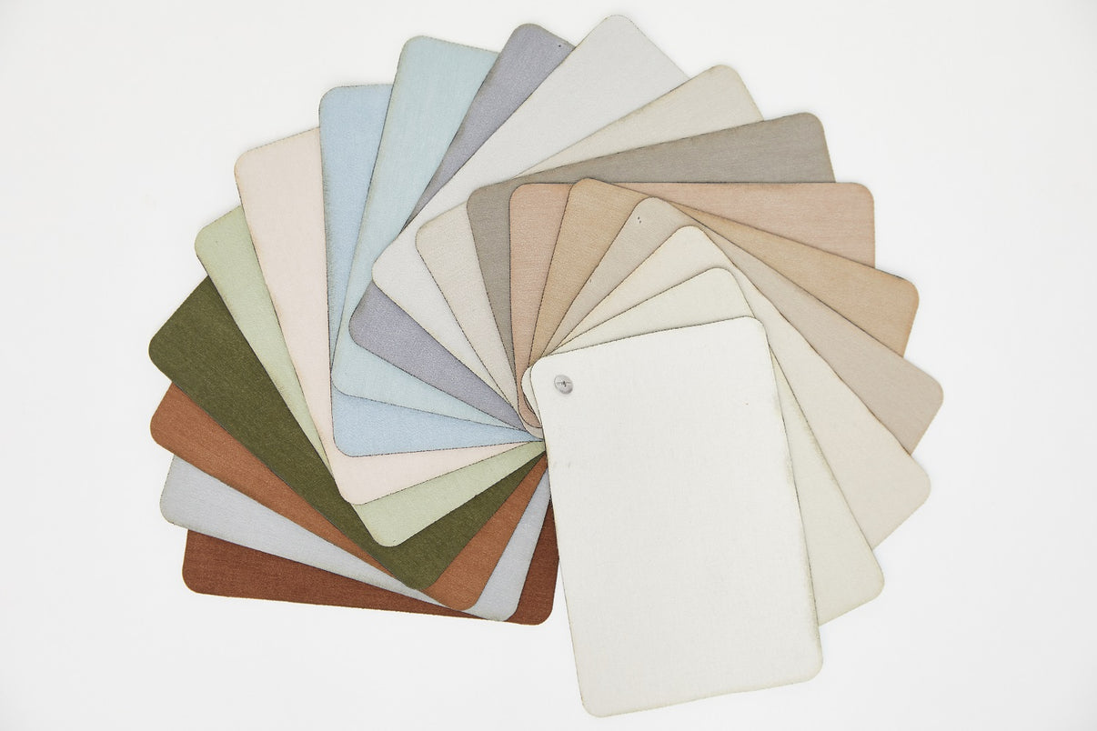 Velourette Chenille blackout curtain fabric swatches fan showcasing 18 color options, including earthy neutrals and grays.