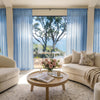 Light blue custom sheer curtains by Joydeco, creating airy ambiance with ocean view.