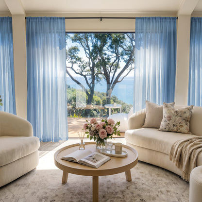 Light blue custom sheer curtains by Joydeco, creating airy ambiance with ocean view.