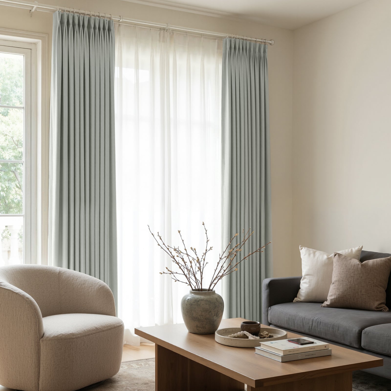Arden Satin custom blackout curtains in soft grey-blue with elegant pleats.