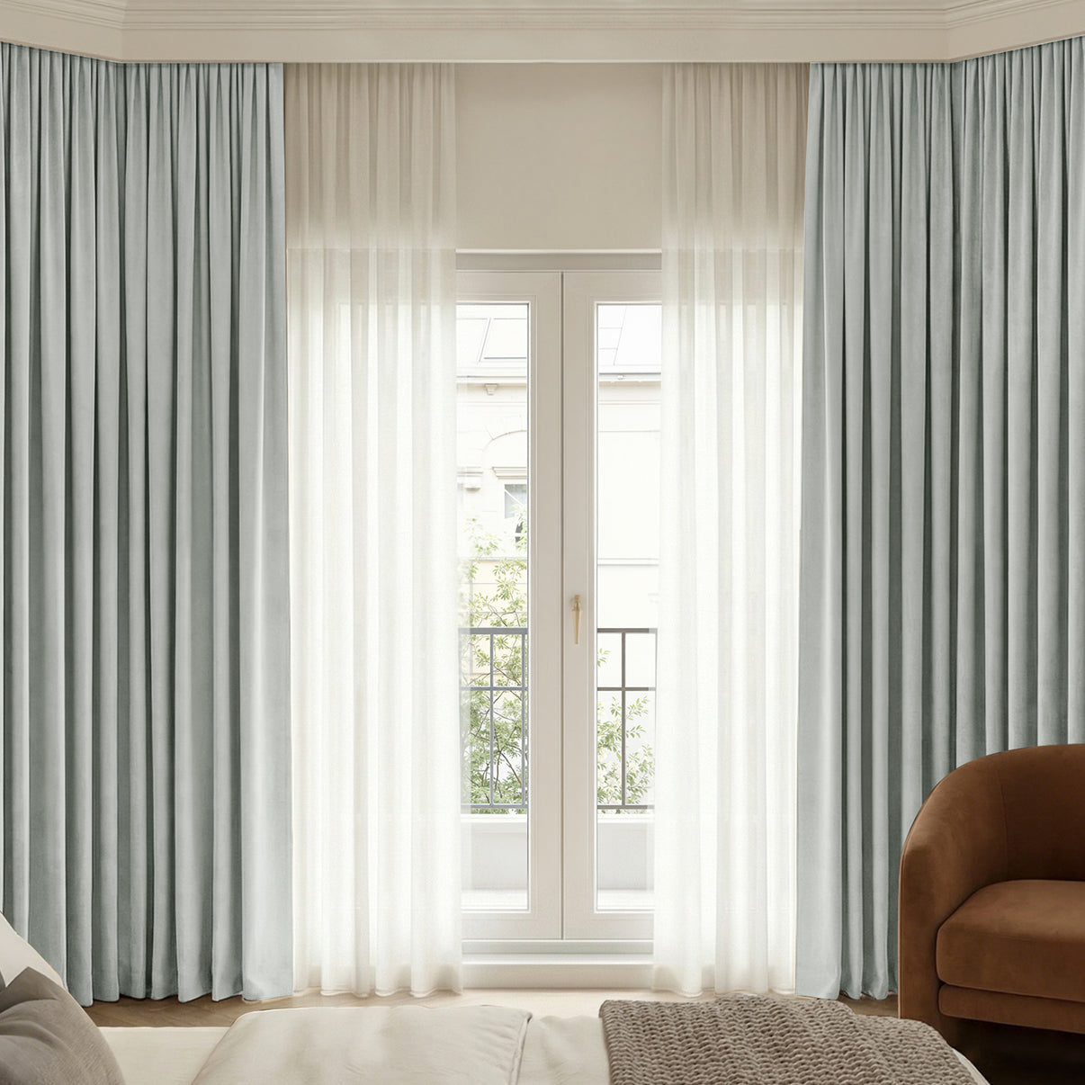 Custom light blue-grey chenille blackout curtains layered with sheer white window treatments.