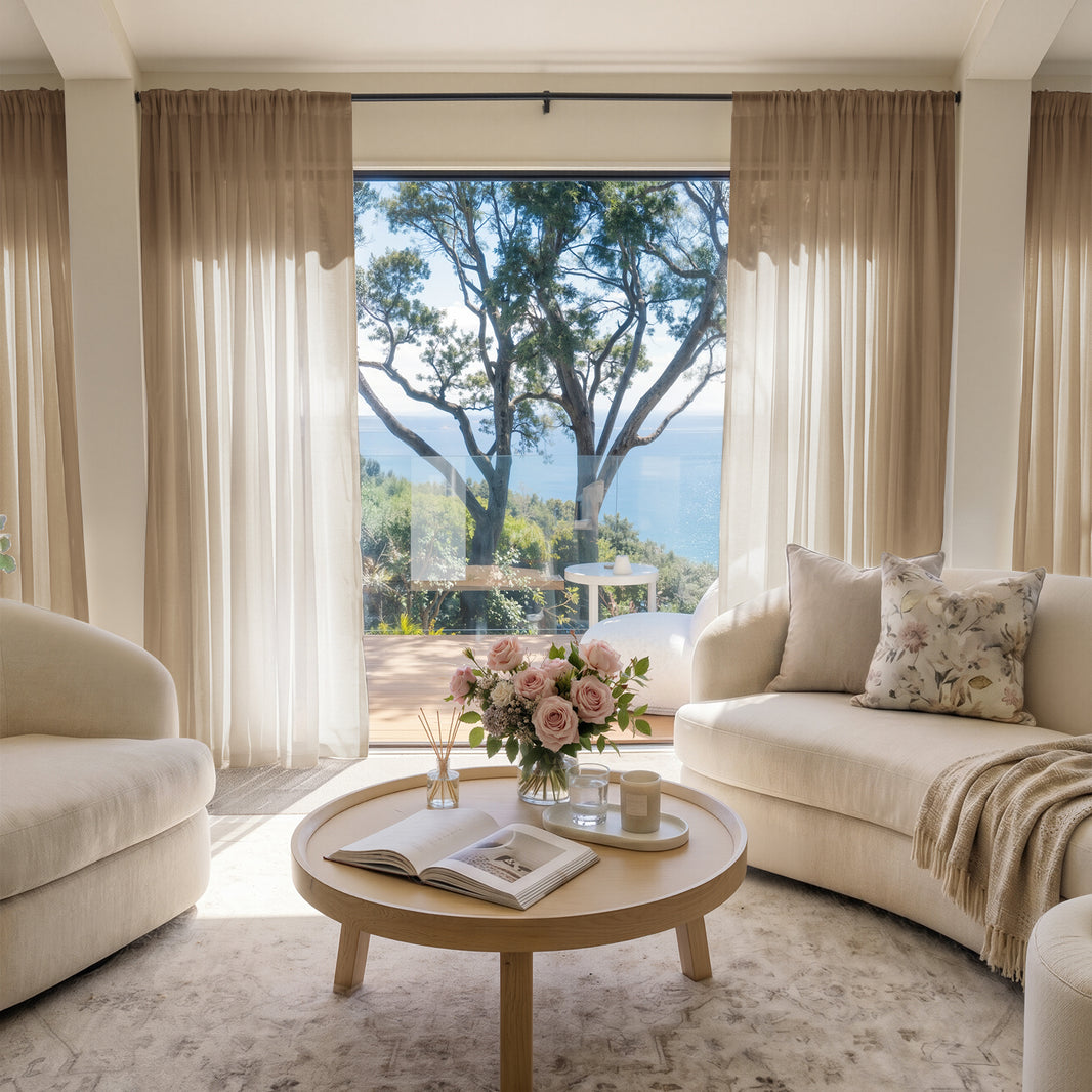 Feather custom lightweight sheer curtains in a bright living room, filtering sunlight, with coastal view.