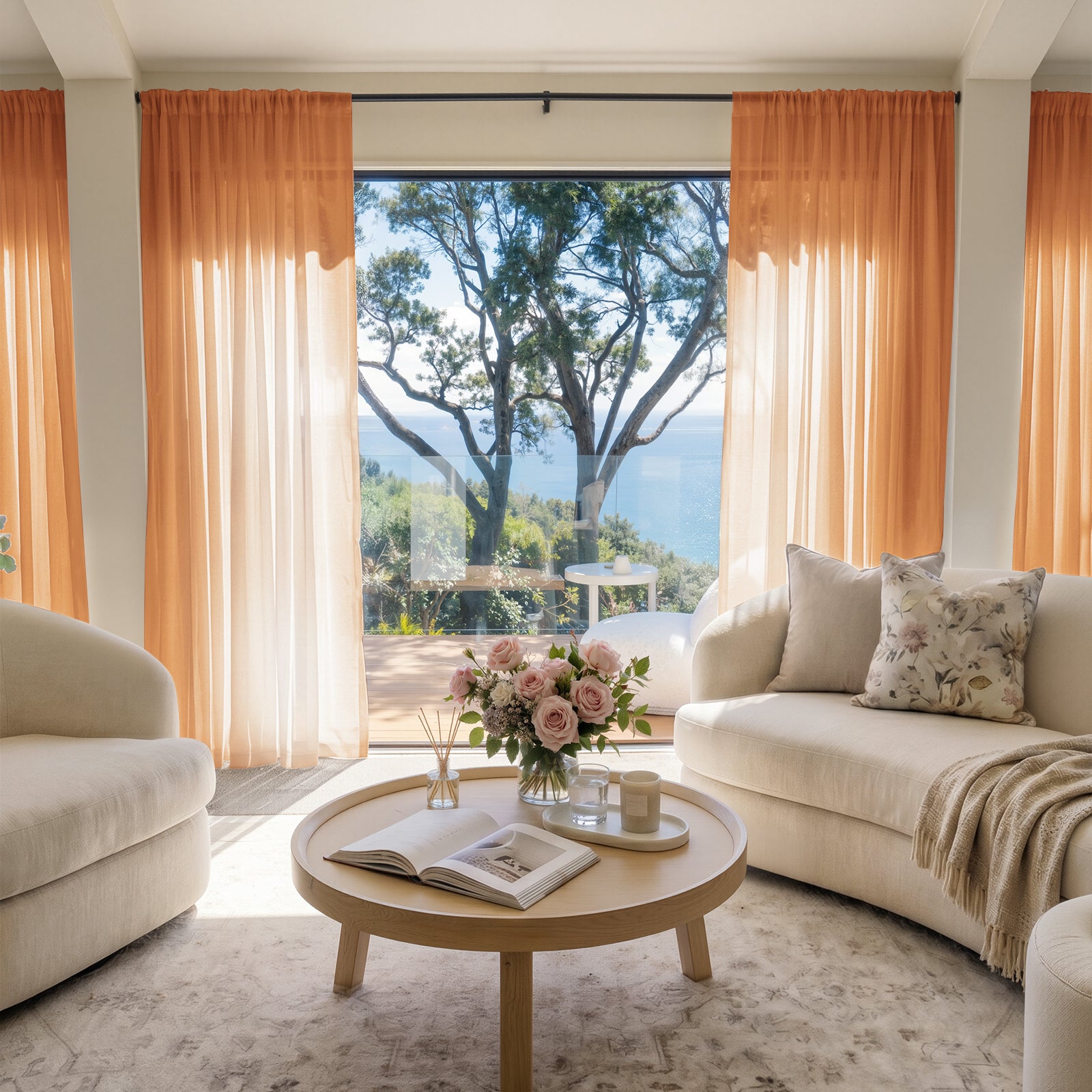 Peach sheer custom curtains creating an airy living room ambiance with an ocean view.