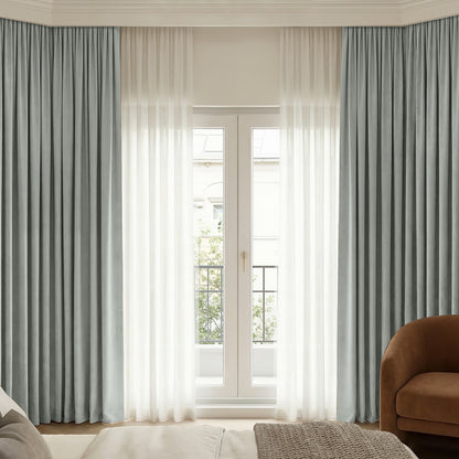 Bennett Chenille grey-blue blackout curtain layered with sheer white drapes.