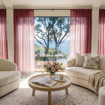 Feather custom lightweight sheer mauve curtains filtering sunlight in elegant living room.