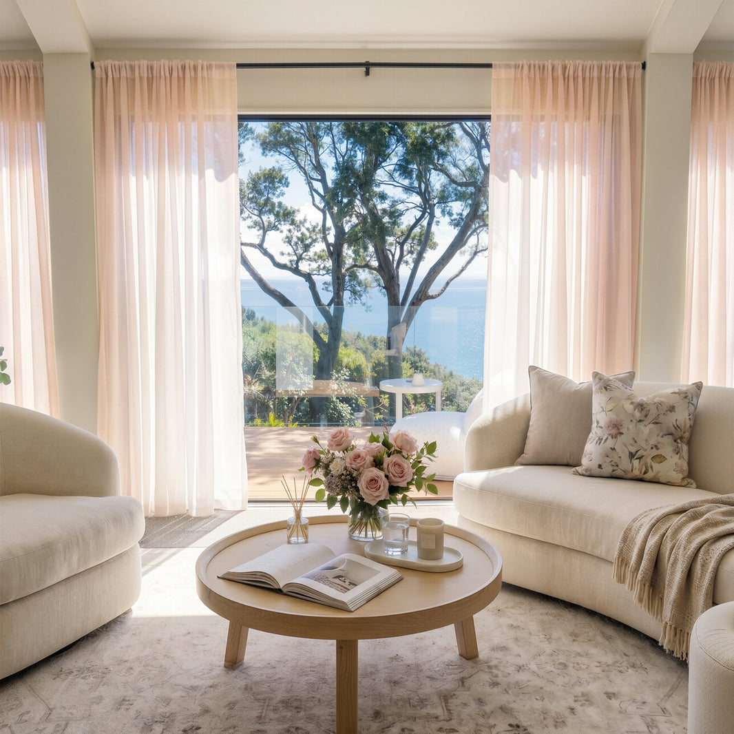 Blush pink Feather lightweight custom sheer curtains enhance airy living room.