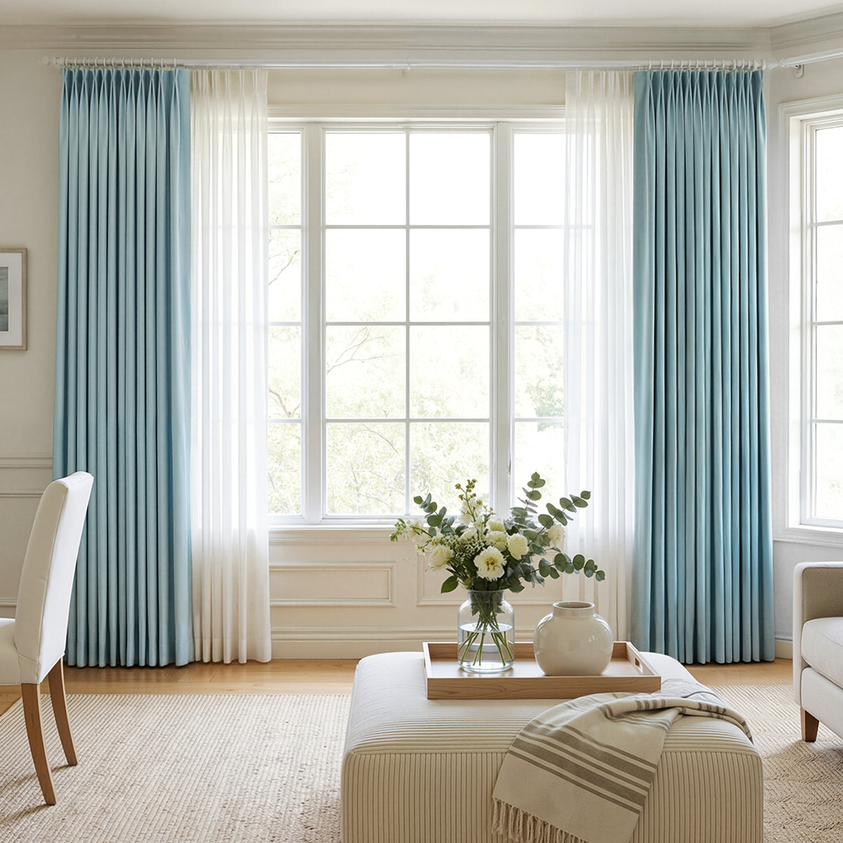 Hayden light blue Chenille blackout curtains layered with sheer white.