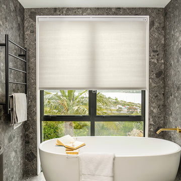 Solace Light Filtering Cellular Shade in cream, offering soft light and privacy for window treatments.
