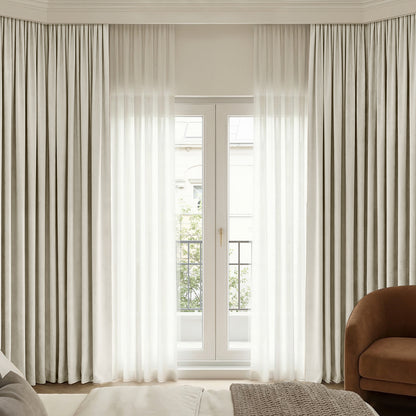 Custom beige Chenille blackout curtains with sheer layering on elegant French doors.