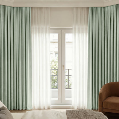 Custom sage green chenille blackout curtains with plush texture and sheer overlay.