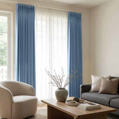 Blue satin blackout custom curtains with lustrous finish and elegant pleats