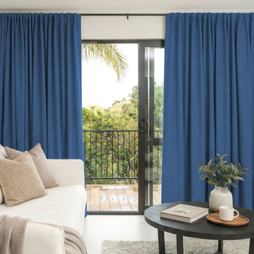 Custom Alder blue faux linen blackout curtains for light control.