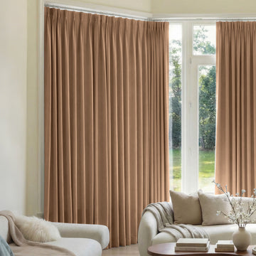 Custom Mason Triple Weave pleated blackout curtains in warm taupe, living room display.