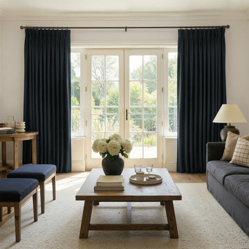 Sloane navy velvet custom room darkening curtains with elegant drape.