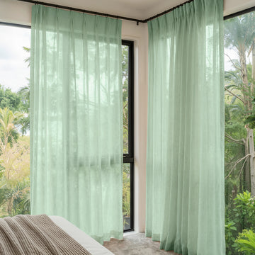 Custom Linden Linen Blend Sheer Curtain in soft green with garden view.