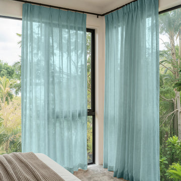 Linden Linen Blend Sheer Curtains in light teal, pleated top, filtering natural light.